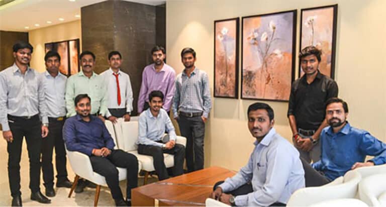 Martech Systems employees dressed in formal business attire pose together for a group photograph