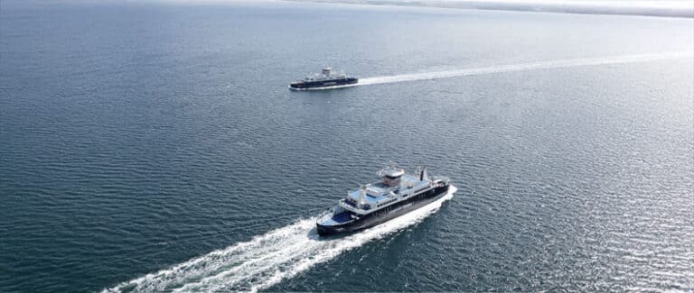 Two ferries passes each other at open sea
