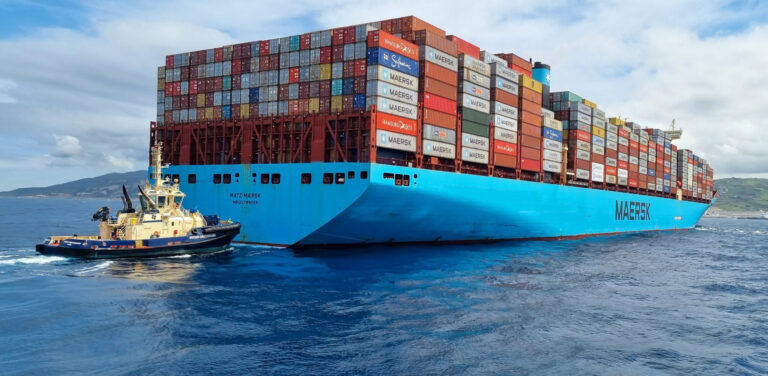 A SVITZER tugboat assisting a MAERSK cargo ship full of containers