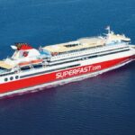 A sideview of a passenger ship sailing across the ocean