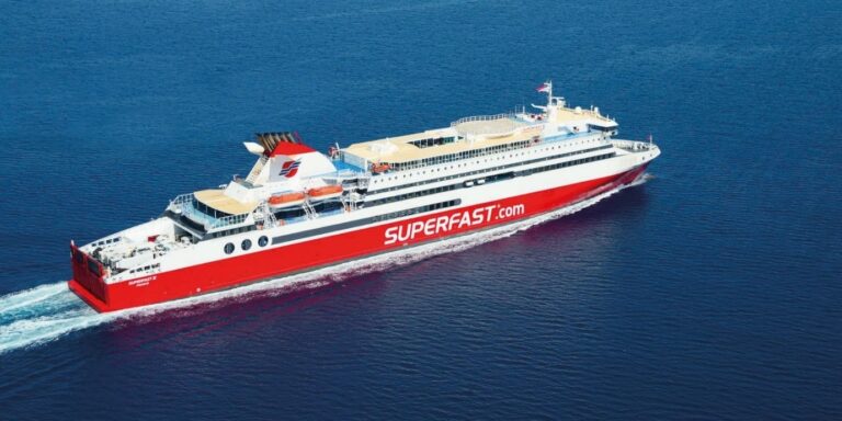 A sideview of a passenger ship sailing across the ocean
