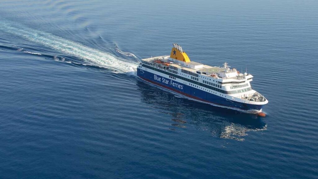 A wide shot of a passenger ship cutting through the sea at great speed