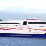 A close-up view from the side of a Condor Ferries passenger ferry
