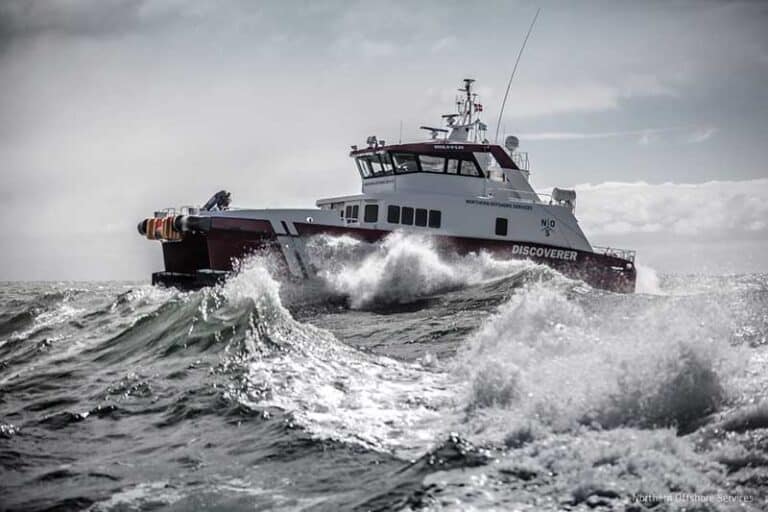 A picture of a maritime vessel sailing wavy seas