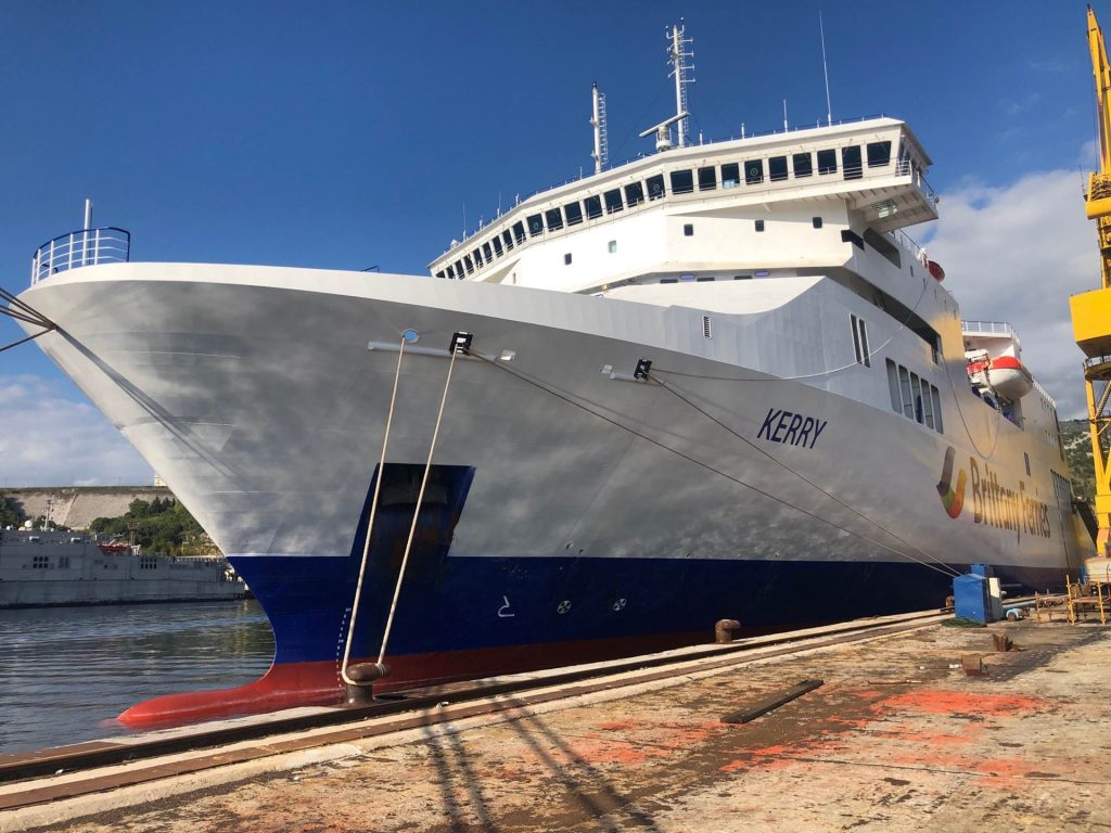 A close-up view of the bow of a Brittany Ferries passenger vessel, docked in a harbor