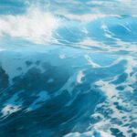 A close up of a sea with foamy waves