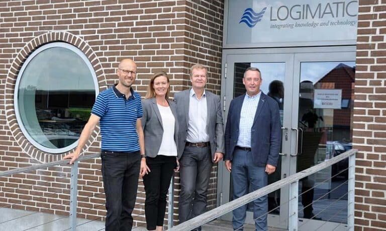 A group photo featuring the CEO and COO of RINA Digital Solutions alongside the Head of Business Development at Special Minds, all posing together facing the camera