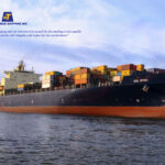 A side view of the Technomar Cargo vessel receiving support from tugboats