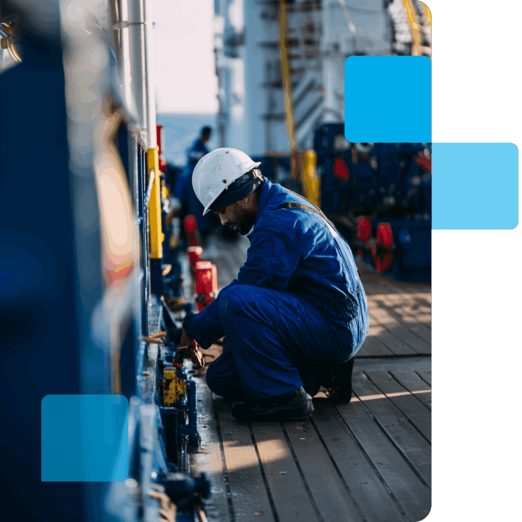 A maritime worker performing maintenance on his vessel
